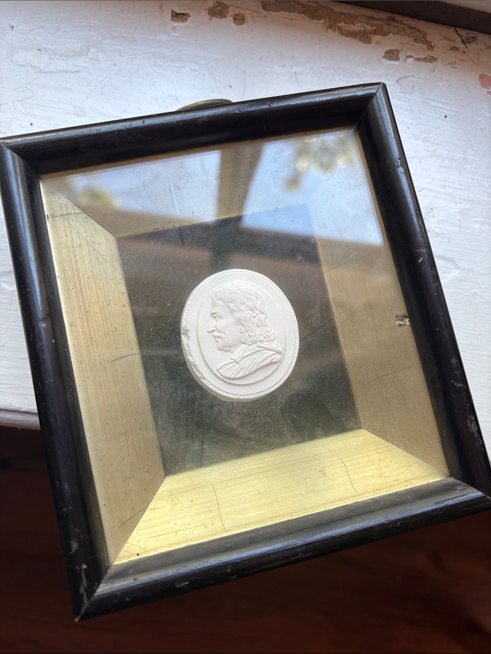 antique plaster intaglio medallion housed in a shadow box frame.